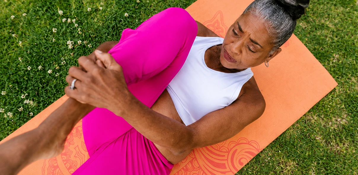 an elder woman doing yoga