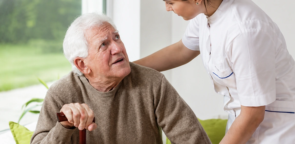 healthcare personnel assisting an elderly